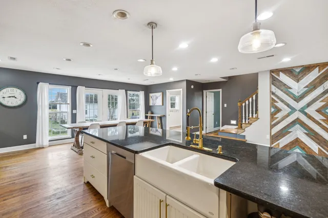 a bedroom with a bed dresser and a window