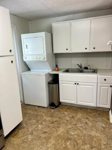 a utility room with cabinets washer and dryer