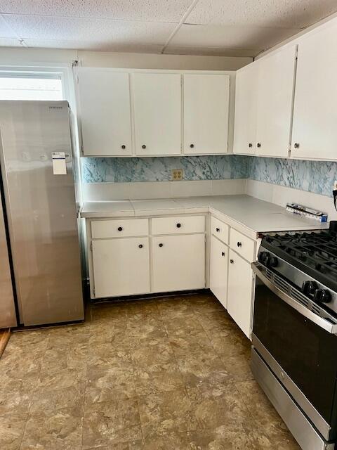 538 West 3rd Street Riviera Beach, FL 33404 - Photo 3 of 10 a kitchen with granite countertop white cabinets and stainless steel appliances