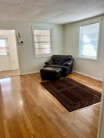 a room with a black white checkered floor living room with a rug