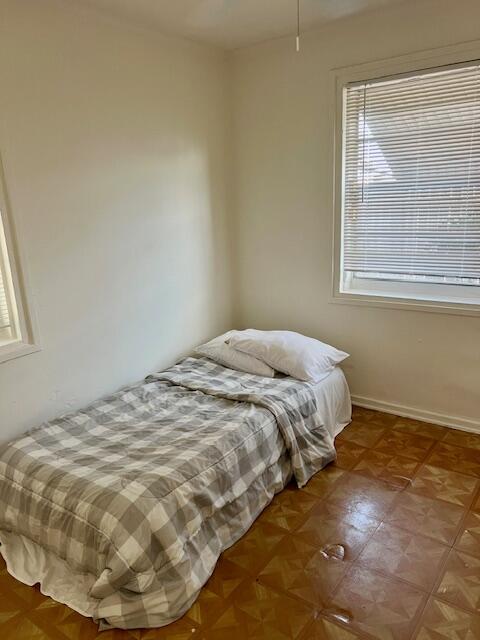 538 West 3rd Street Riviera Beach, FL 33404 - Photo 7 of 10 a bed sitting in a bedroom next to a window