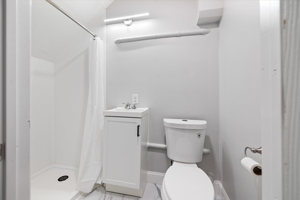 17 Otis Street Warren, MA 01083 - Photo 21 of 26 a bathroom with a toilet a sink and shower