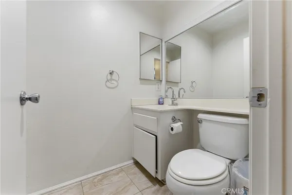a bathroom with a sink toilet vanity and mirror