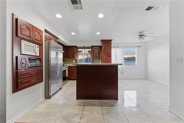 a kitchen with stainless steel appliances granite countertop a refrigerator and a sink