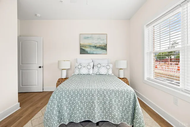 a bedroom with a bed and wooden floor