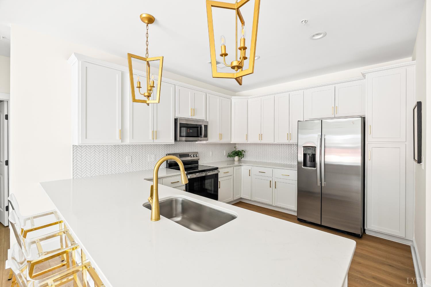 420 Capstone Drive, Unit 205 Lynchburg, VA 24502 - Photo 5 of 47 a kitchen with stainless steel appliances granite countertop a sink a stove a refrigerator a washer dryer and white cabinets