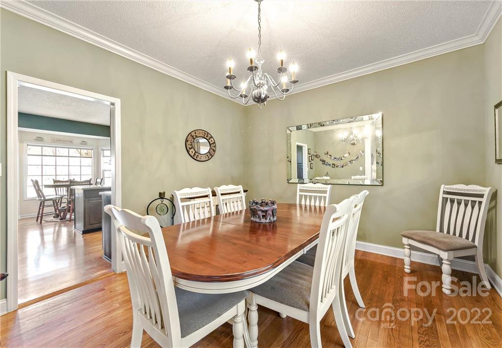 505 Kings Ridge Asheville, NC 28804 - Photo 13 of 38 a dining room with furniture a chandelier and wooden floor