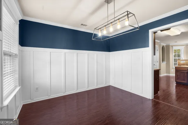 a kitchen with stainless steel appliances a stove a sink and a microwave