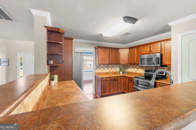 a kitchen with stainless steel appliances granite countertop a sink and dishwasher with wooden floor