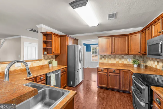 a view of a living room and kitchen with wooden floor