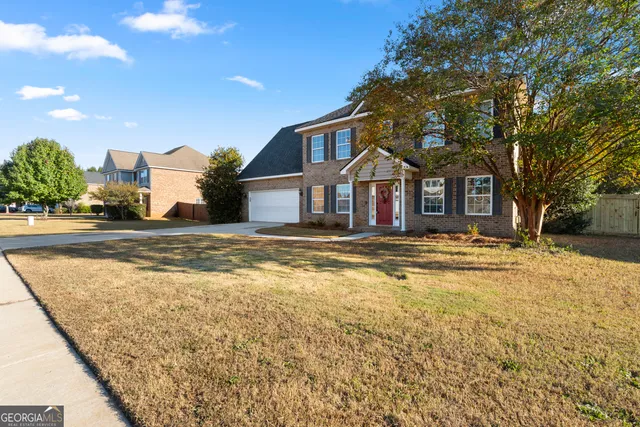 a front view of a house with a yard