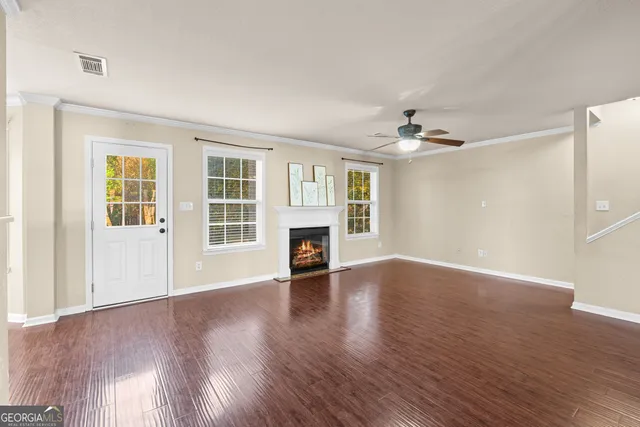a view of a room with a ceiling fan and window