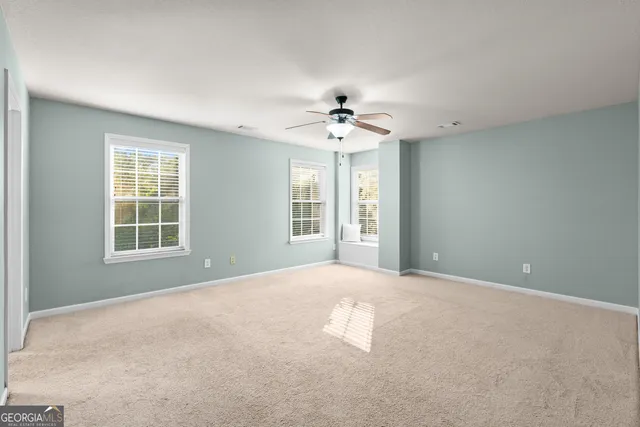 a bathroom with a tub shower and window