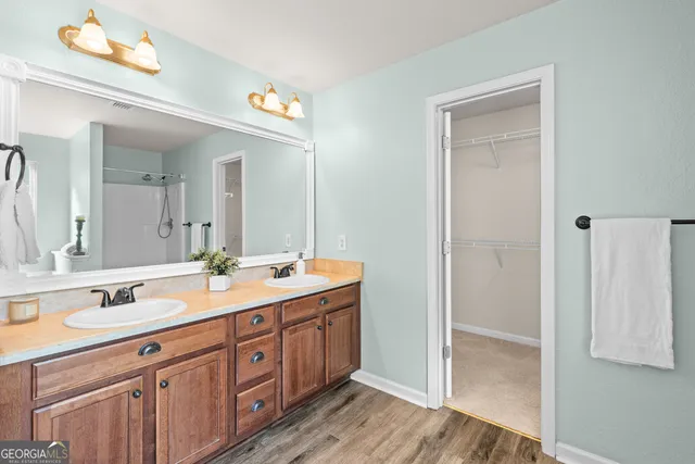 a view of a hallway with wooden floor and windows