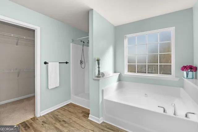 a bathroom with a granite countertop sink a large mirror and a shower