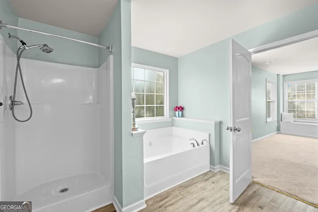 en empty room with windows and fan