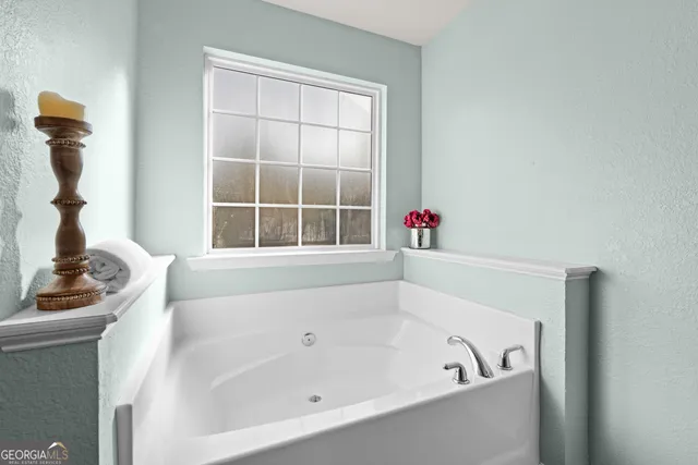 a view of a livingroom with a ceiling fan and window