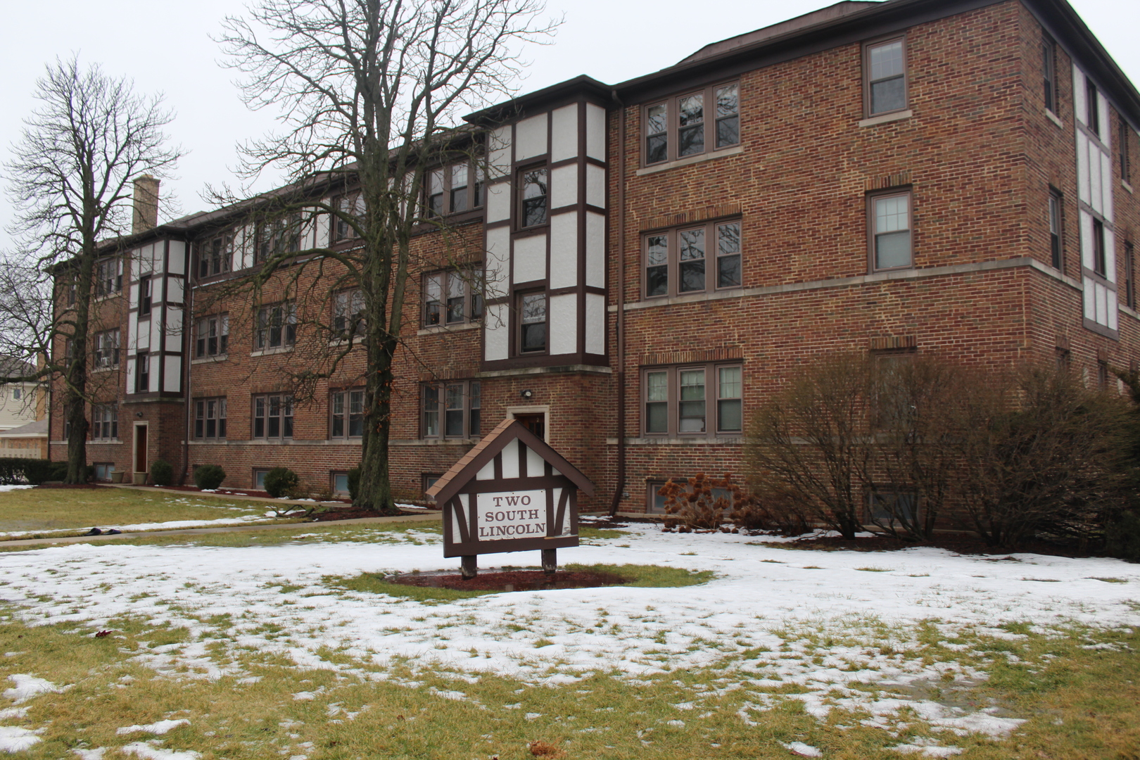 a front view of a building with a yard