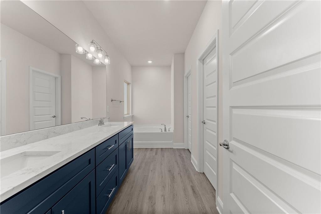 646 Bald Ridge Circle Demorest, GA 30535 - Photo 14 of 28 a spacious bathroom with a double vanity sink a mirror and a shower