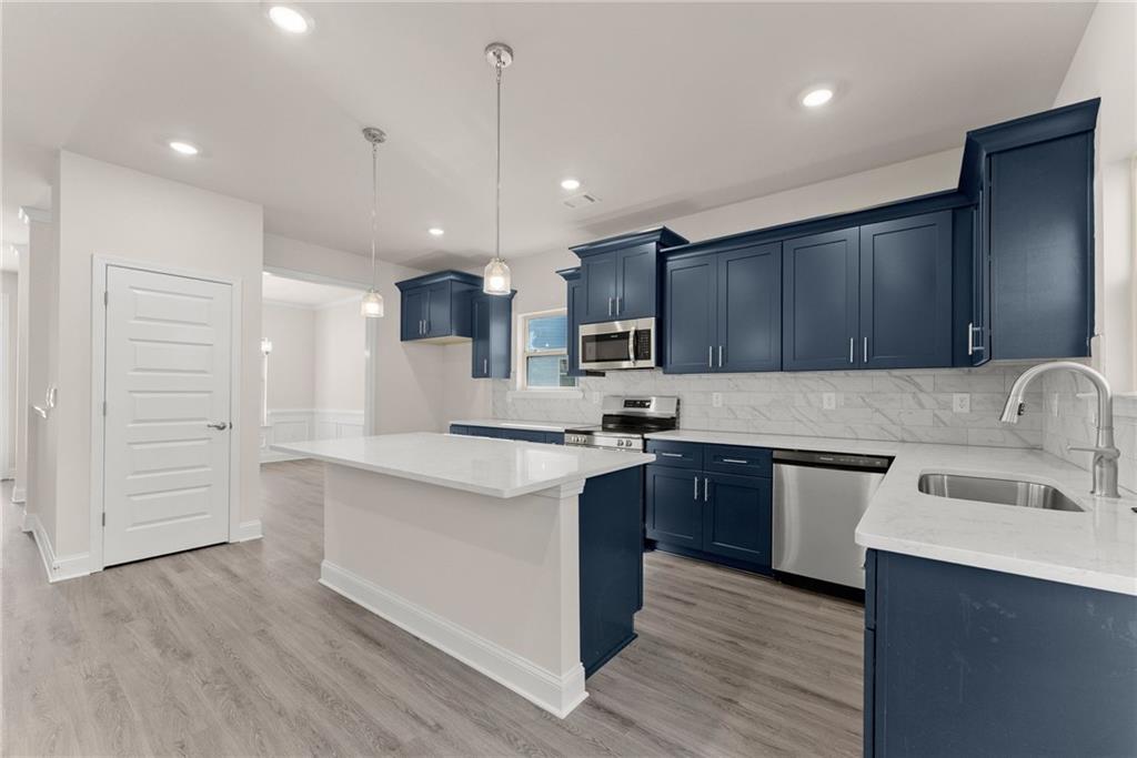 646 Bald Ridge Circle Demorest, GA 30535 - Photo 8 of 28 a kitchen with kitchen island granite countertop wooden cabinets and white appliances