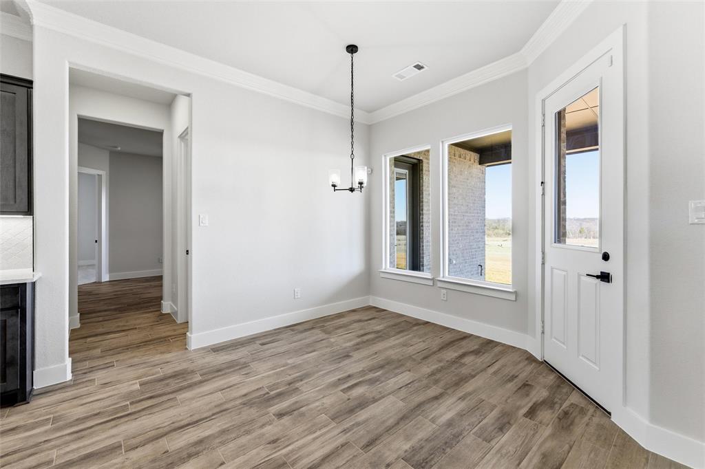805 Vly Rdg Road Van Alstyne, TX 75495 - Photo 20 of 40 a view of empty room with wooden floor and fan