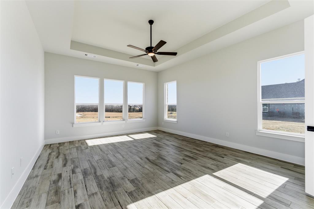 805 Vly Rdg Road Van Alstyne, TX 75495 - Photo 33 of 40 a view of an empty room with a window and wooden floor