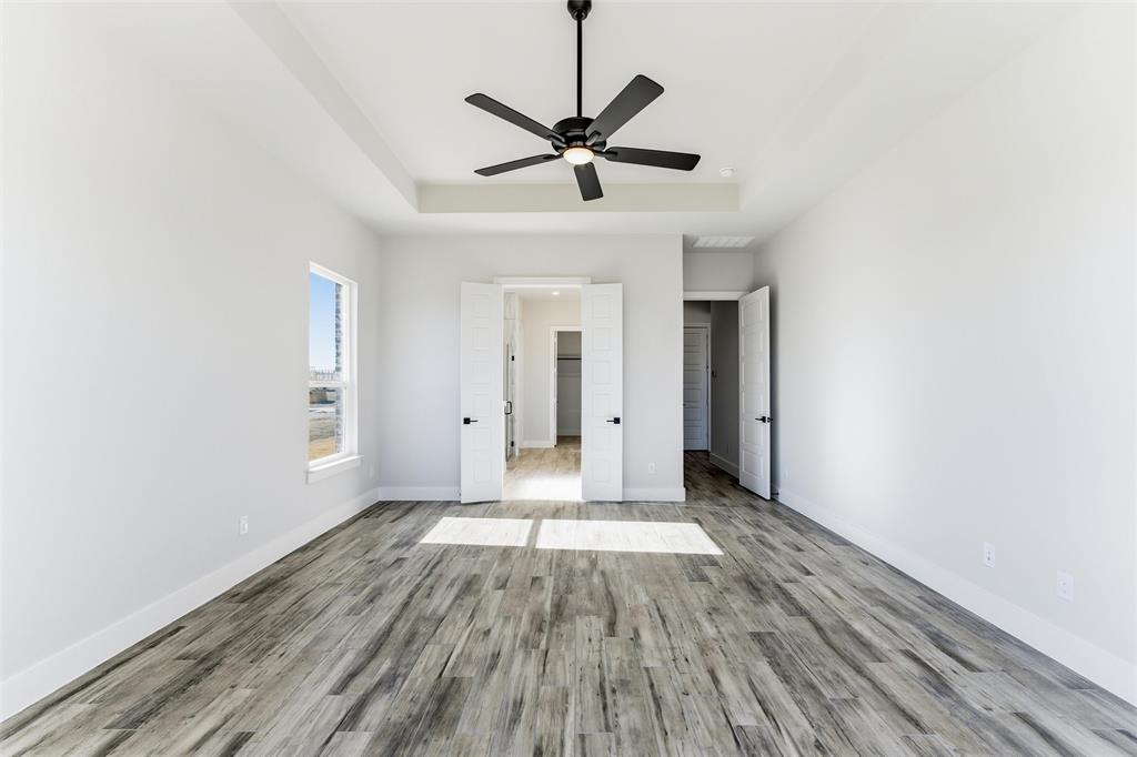 805 Vly Rdg Road Van Alstyne, TX 75495 - Photo 34 of 40 a view of a room with wooden floor and ceiling fan