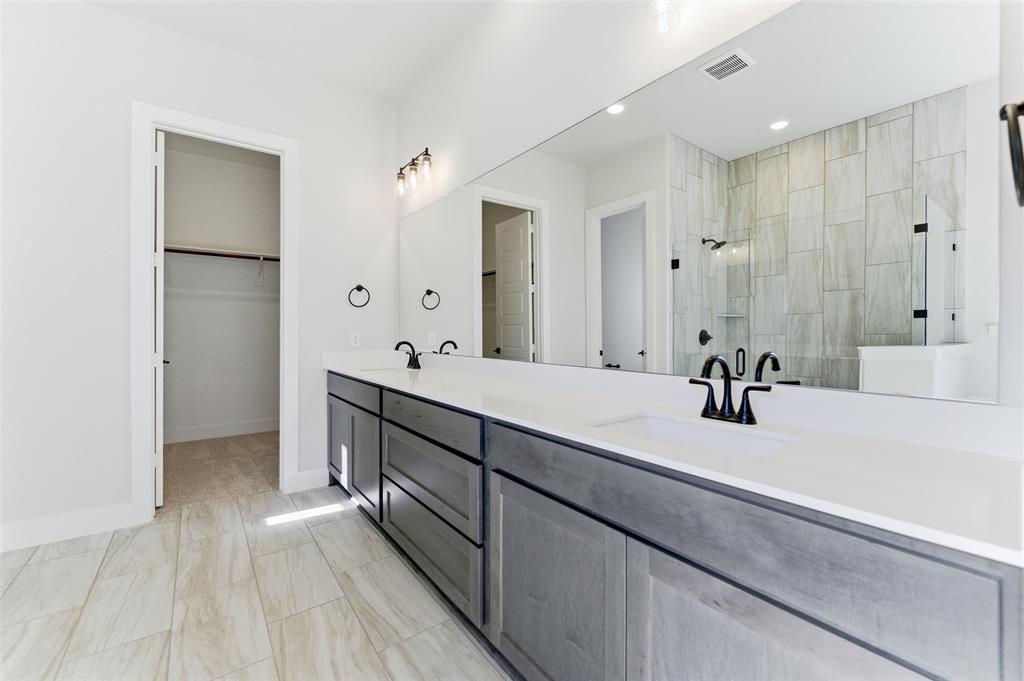 805 Vly Rdg Road Van Alstyne, TX 75495 - Photo 36 of 40 a spacious bathroom with a double vanity sink double and mirror