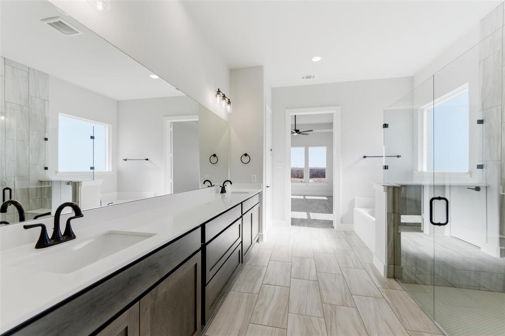 805 Vly Rdg Road Van Alstyne, TX 75495 - Photo 37 of 40 a view of a kitchen with kitchen island a sink wooden floor and stainless steel appliances