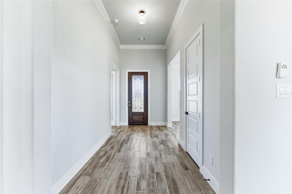 805 Vly Rdg Road Van Alstyne, TX 75495 - Photo 8 of 40 a view of a hallway with wooden floor