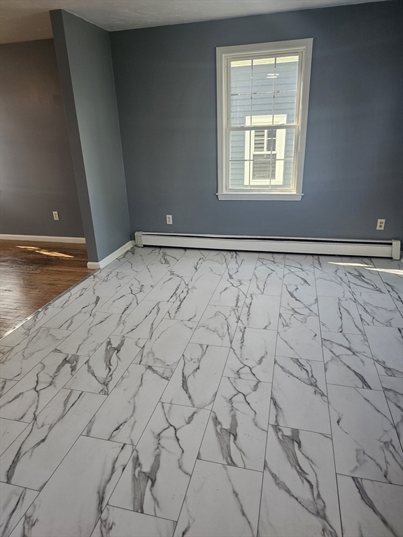 40 Merrick Street, Unit A Worcester, MA 01609 - Photo 5 of 32 a view of an empty room with window and wooden floor