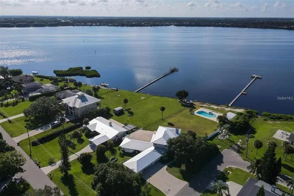 an aerial view of a house with a lake view