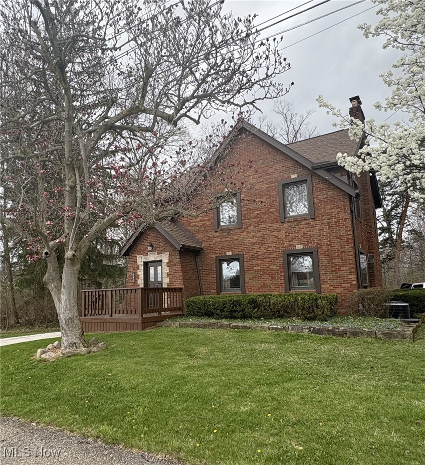 640 South Cleveland Massillon Road Akron, OH 44321 - Photo 1 of 1 View of front facade with a deck, brick siding, and a front lawn