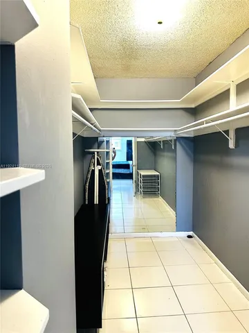 a view of a hallway with chairs and a table
