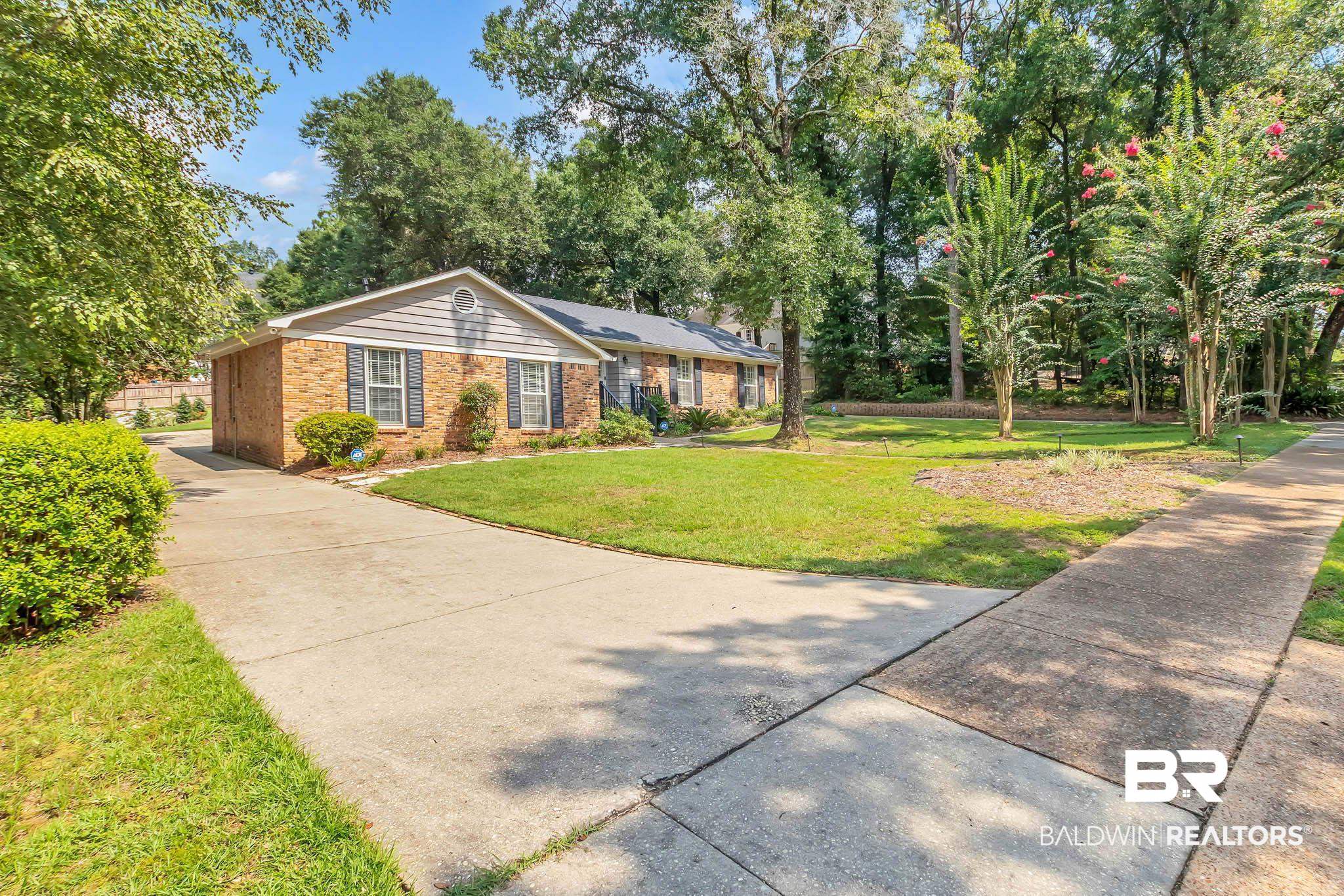 309 West Brandy Run Road Mobile, AL 36608 - Photo 7 of 100 Single story home featuring a front lawn, brick siding, and concrete driveway