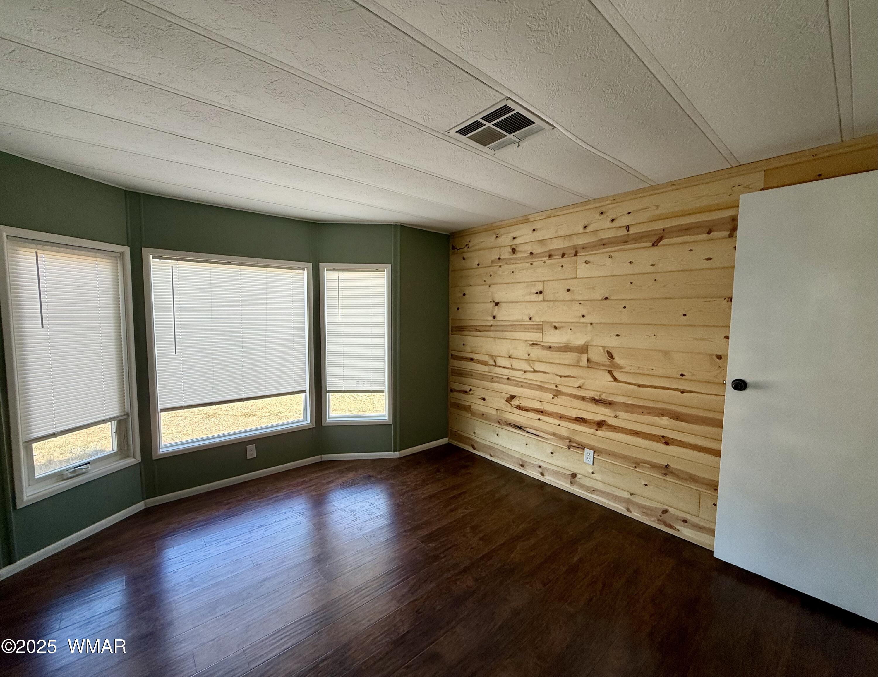 3908 South Freeman Holw Road Snowflake, AZ 85937 - Photo 19 of 31 wooden floor in an empty room with a window