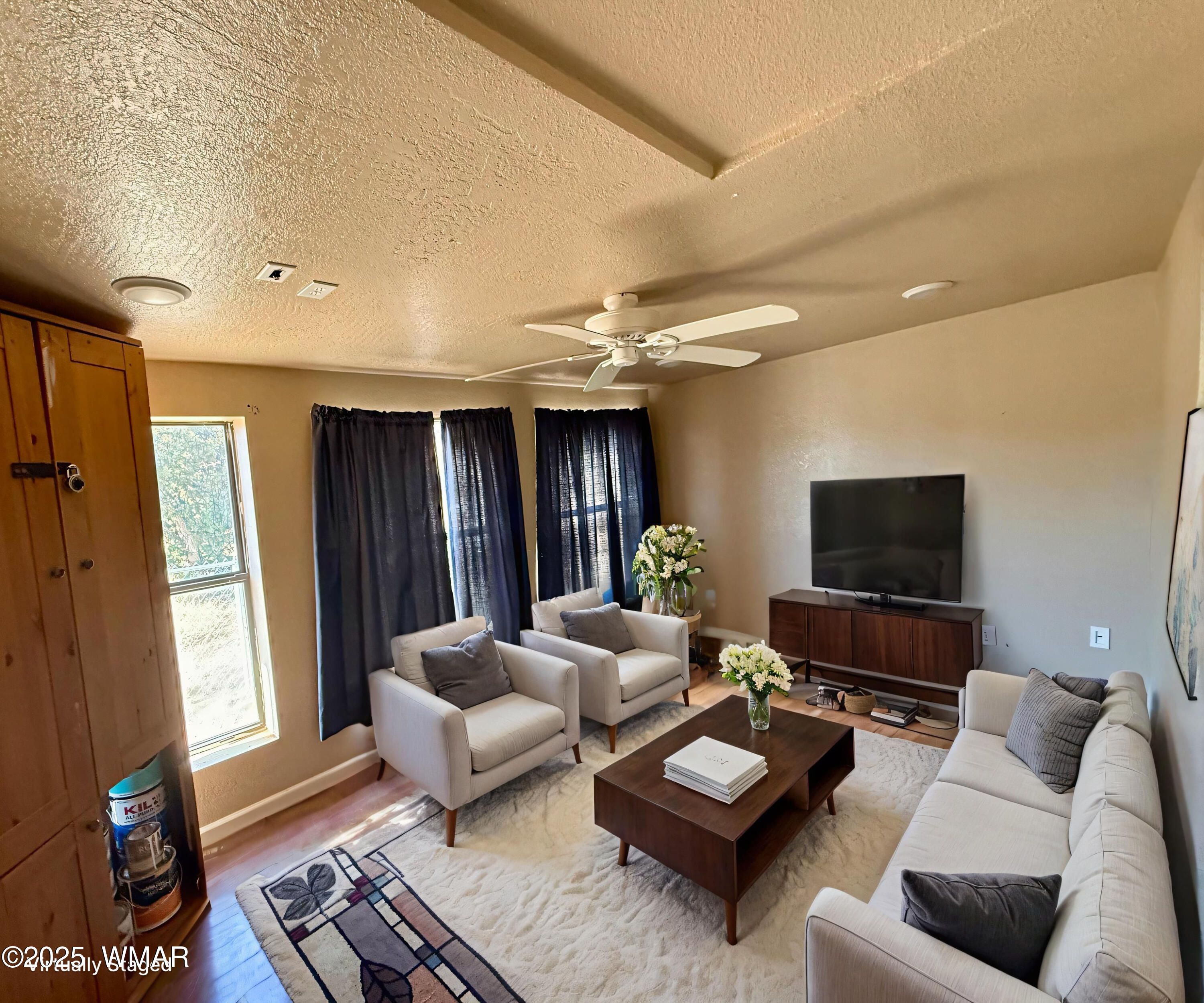3908 South Freeman Holw Road Snowflake, AZ 85937 - Photo 21 of 31 a living room with furniture and a flat screen tv