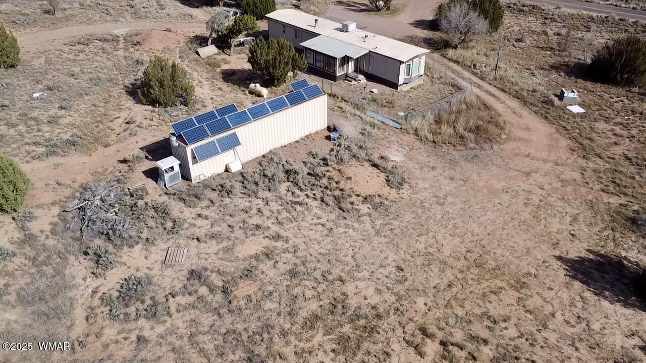 3908 South Freeman Holw Road Snowflake, AZ 85937 - Photo 28 of 31 an aerial view of a backyard with plants and wooden bench