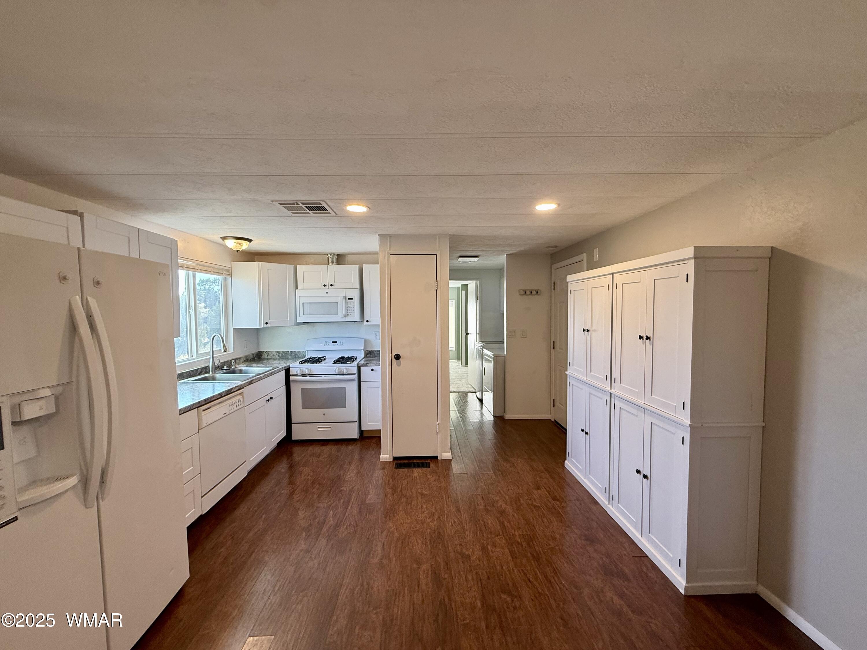 3908 South Freeman Holw Road Snowflake, AZ 85937 - Photo 6 of 31 a kitchen with white cabinets and stainless steel appliances