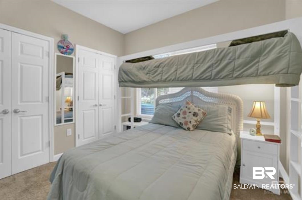 430 West Fort Morgan Road Gulf Shores, AL 36542 - Photo 21 of 27 Bedroom featuring a built-in lofted bed structure, white panel doors, and neutral carpeting