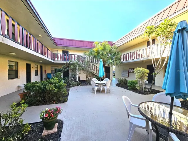 a view of a chairs and table in a patio