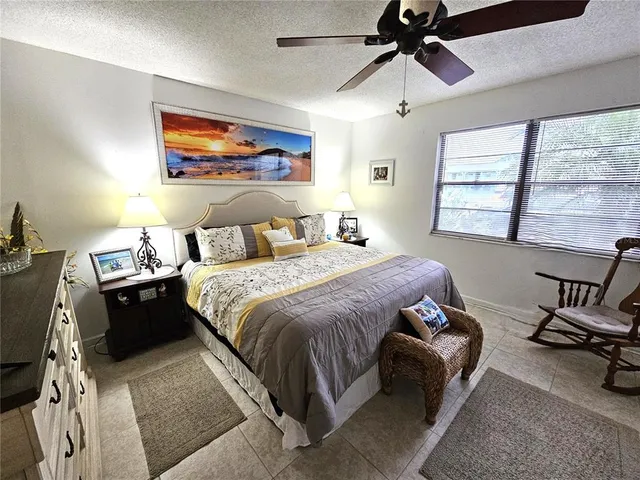 a bedroom with a bed a couch and a window