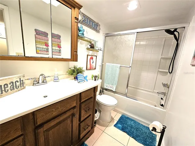 a bathroom with a sink toilet a mirror and shower
