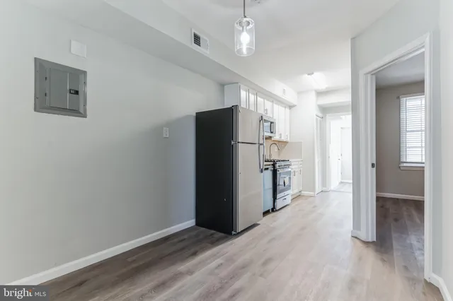 a view of a kitchen with a refrigerator and a sink