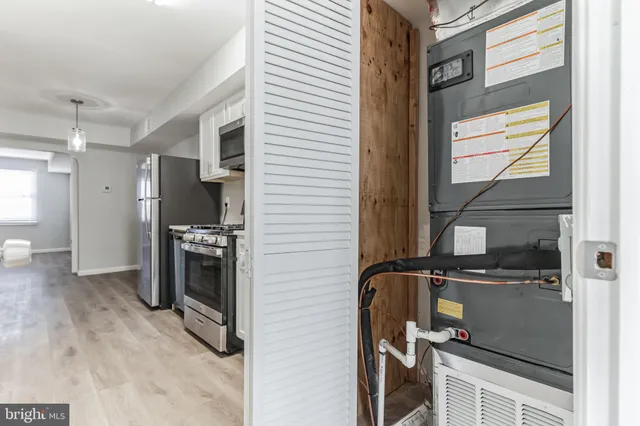 a view of a kitchen with refrigerator and windows
