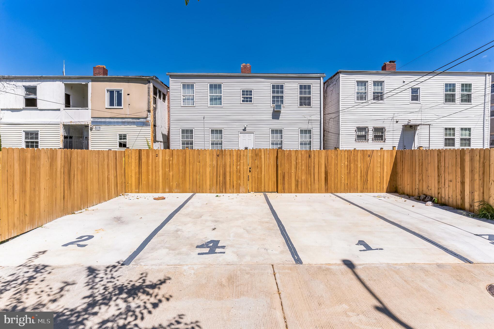 1223 Simms Place Northeast, Unit 1 Washington, DC 20002 - Photo 2 of 48 a view of a building with wooden fence