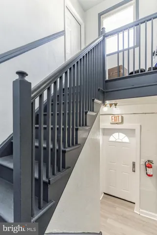a view of staircase with railing and a rug
