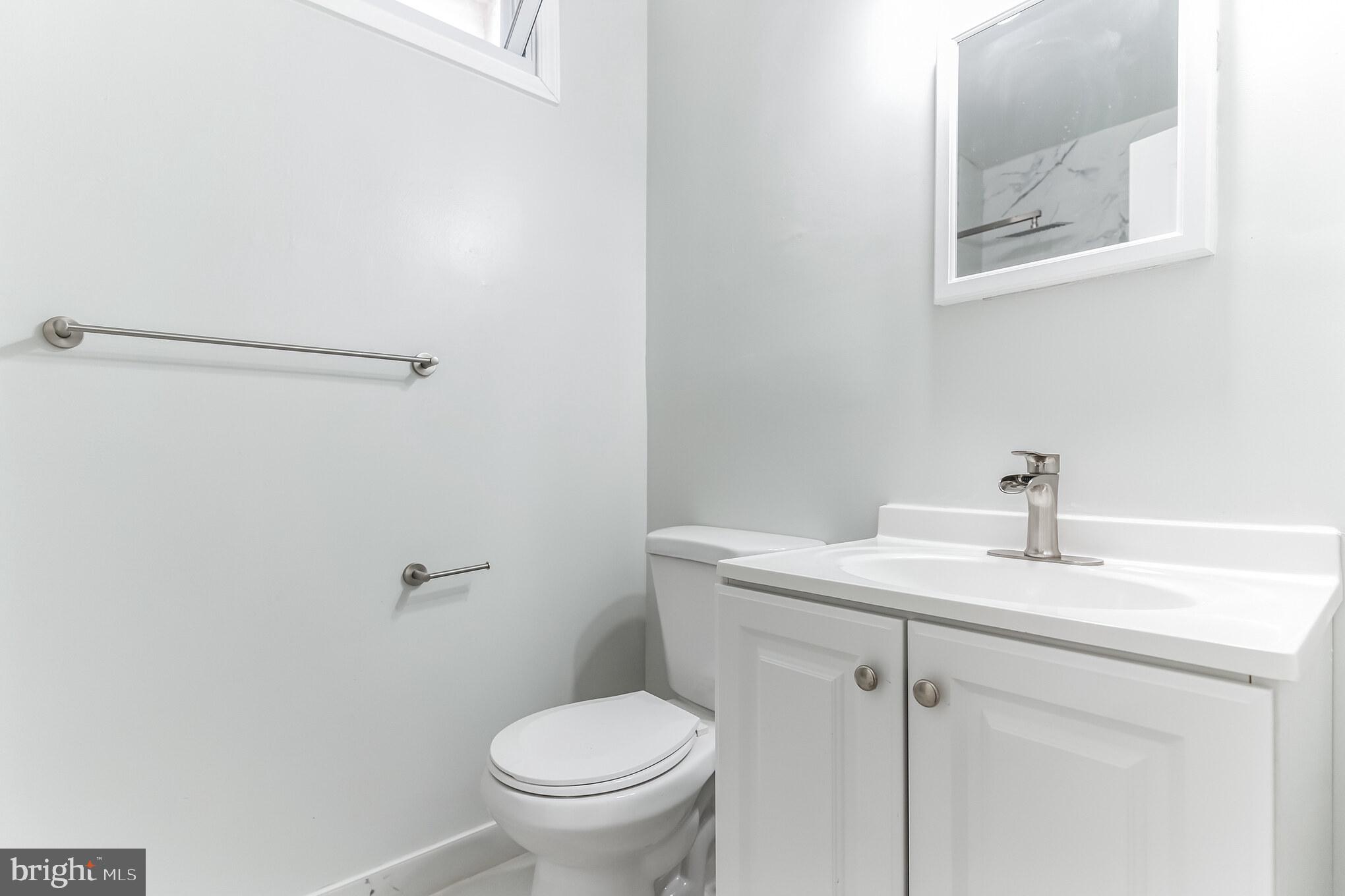 1223 Simms Place Northeast, Unit 1 Washington, DC 20002 - Photo 27 of 48 a bathroom with a sink mirror vanity and toilet