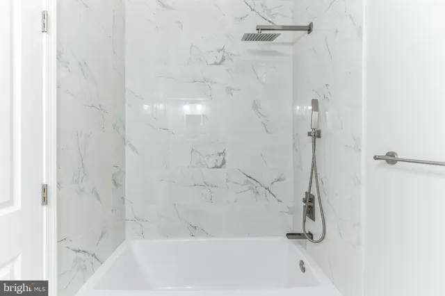 a bathroom with a shower and a bath tub