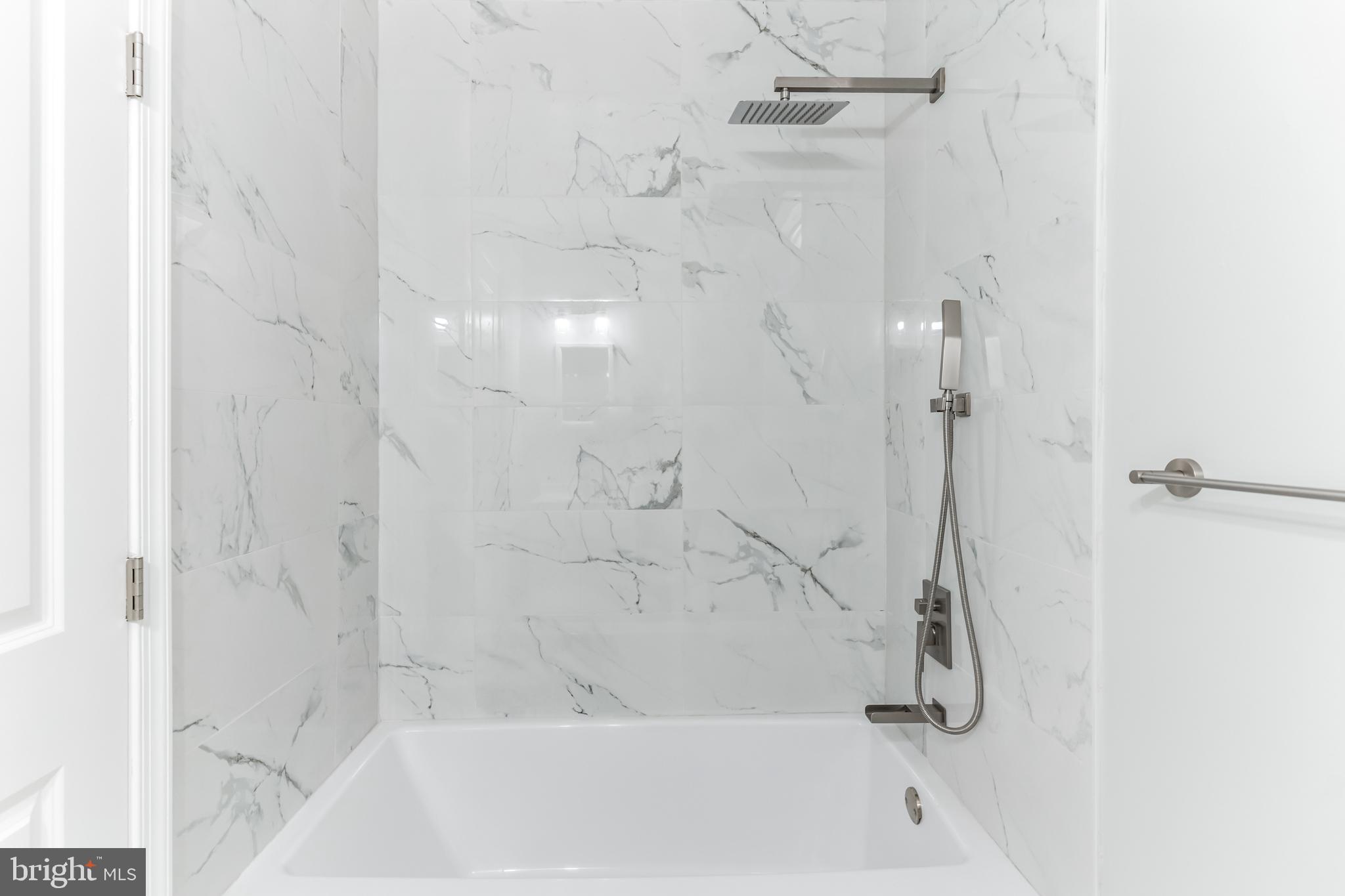 1223 Simms Place Northeast, Unit 1 Washington, DC 20002 - Photo 28 of 48 a bathroom with a shower and a bath tub